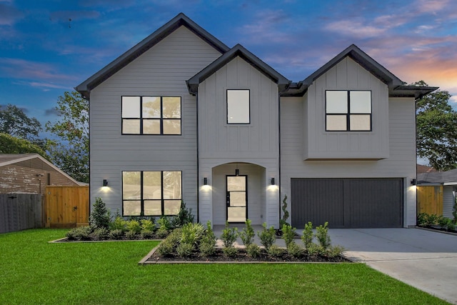 view of front of property with a yard and a garage