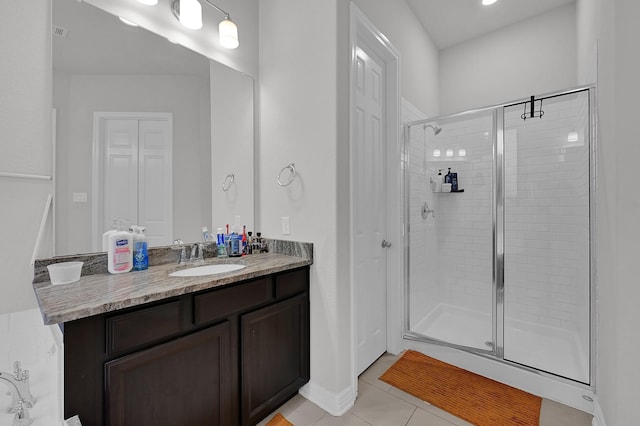 bathroom featuring walk in shower, tile patterned floors, and vanity