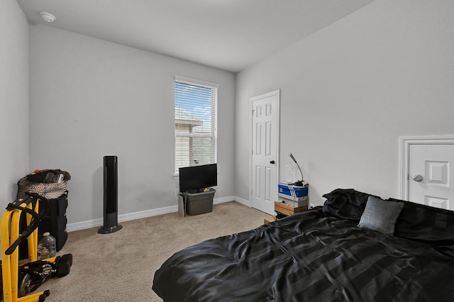 bedroom featuring light carpet