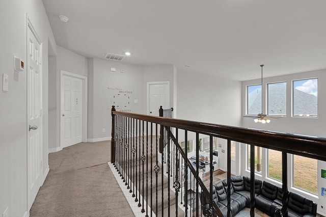 hallway with light colored carpet