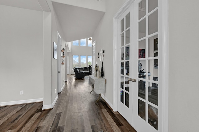 hallway featuring dark hardwood / wood-style flooring, french doors, and a high ceiling