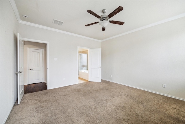 unfurnished bedroom with ceiling fan, ensuite bath, ornamental molding, and dark colored carpet