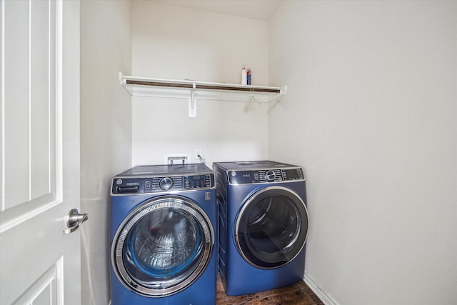 clothes washing area featuring dark hardwood / wood-style flooring and separate washer and dryer