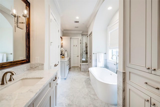 bathroom with vanity, crown molding, and plus walk in shower