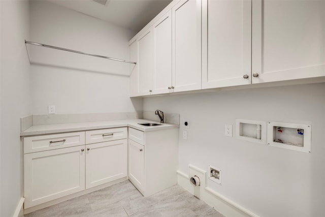 laundry area with sink, hookup for a washing machine, cabinets, hookup for a gas dryer, and hookup for an electric dryer