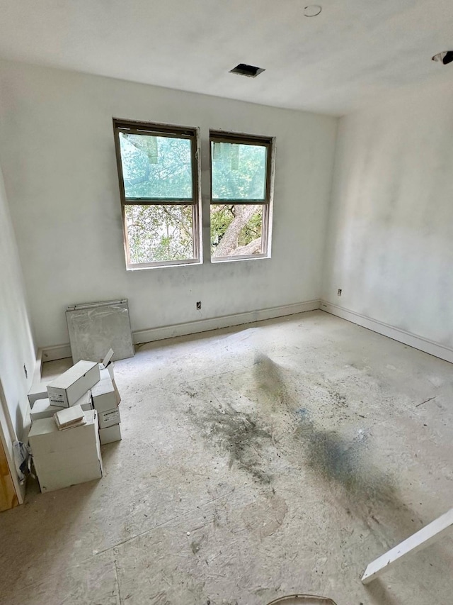 2434 Quenby St, Houston, TX 77005 - spare room featuring unfinished concrete flooring