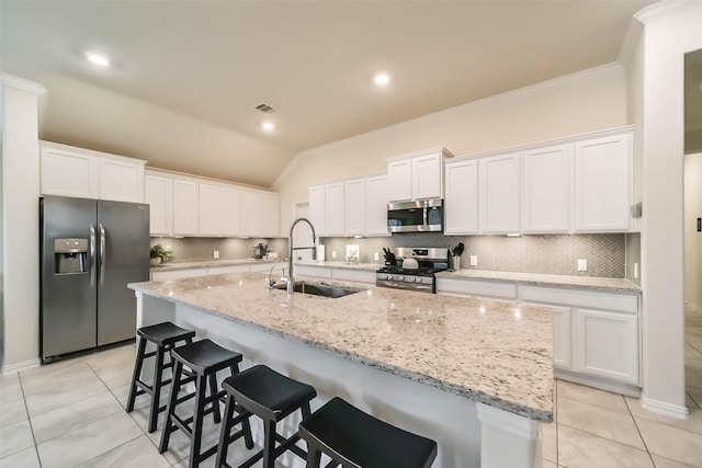 kitchen with sink, an island with sink, white cabinets, and appliances with stainless steel finishes