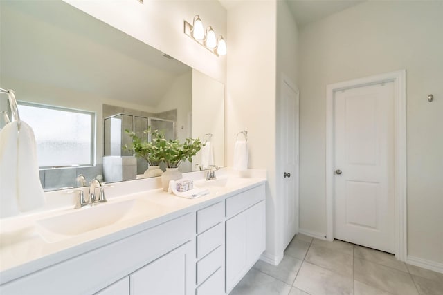 bathroom with tile patterned flooring, vanity, lofted ceiling, and walk in shower