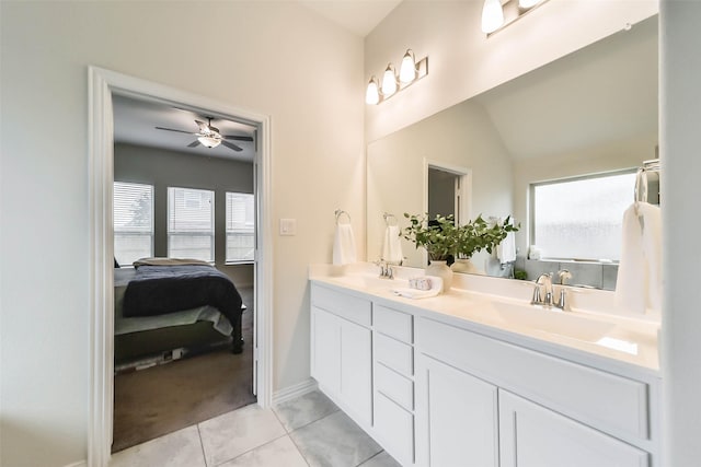 bathroom featuring ceiling fan, vanity, tile patterned flooring, and lofted ceiling