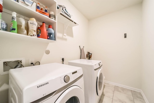 washroom with light tile patterned floors and washing machine and clothes dryer