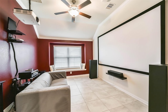 tiled home theater with crown molding, vaulted ceiling, and ceiling fan