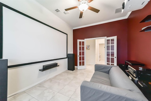 home theater room featuring french doors, ceiling fan, crown molding, and light tile patterned floors