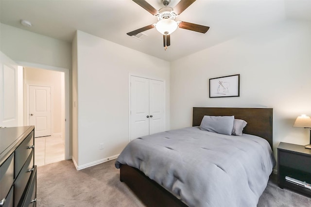 carpeted bedroom featuring ceiling fan and a closet