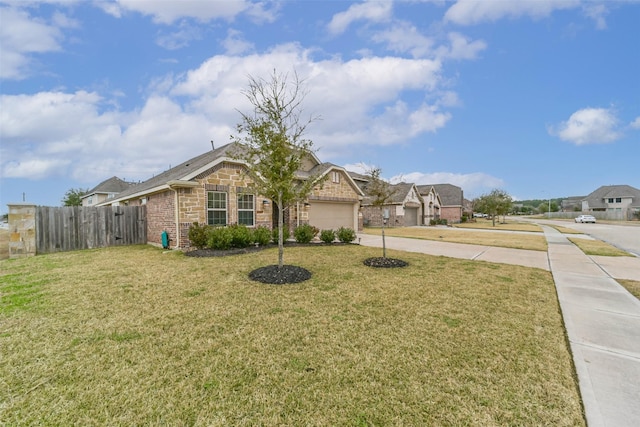 view of front of house with a garage and a front lawn