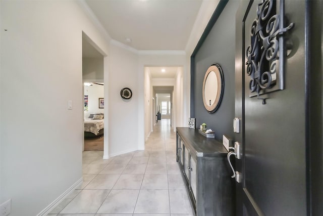 hallway featuring light tile patterned floors and ornamental molding