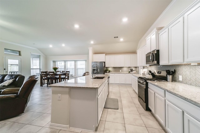 kitchen with a kitchen island with sink, sink, stainless steel appliances, and white cabinets