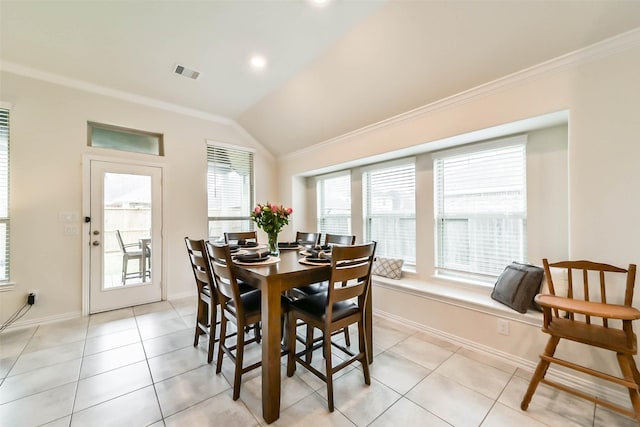 tiled dining area with lofted ceiling and ornamental molding