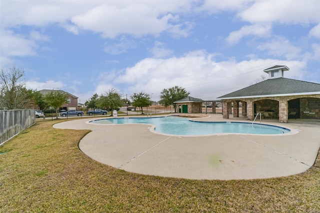 view of swimming pool with a patio area and a lawn