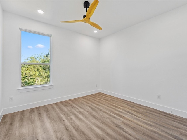 empty room with ceiling fan and light hardwood / wood-style floors