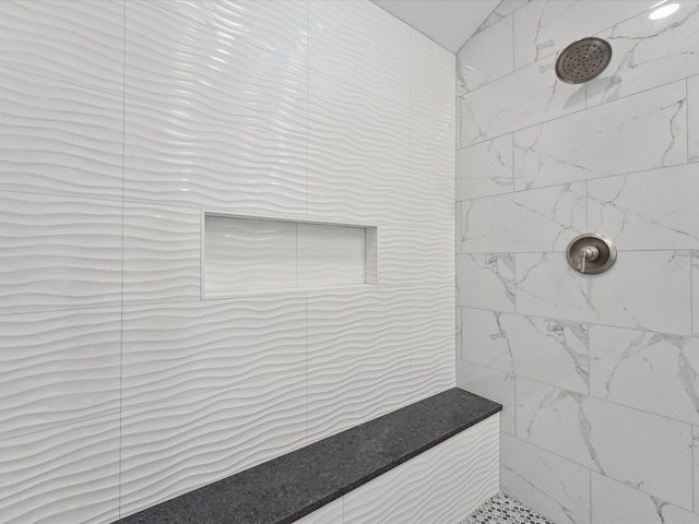 bathroom with a tile shower