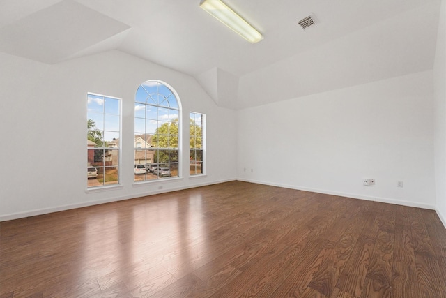 spare room with lofted ceiling and dark hardwood / wood-style floors