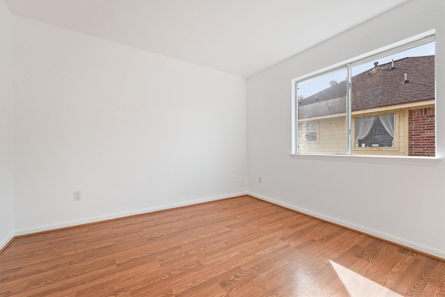 unfurnished room with wood-type flooring