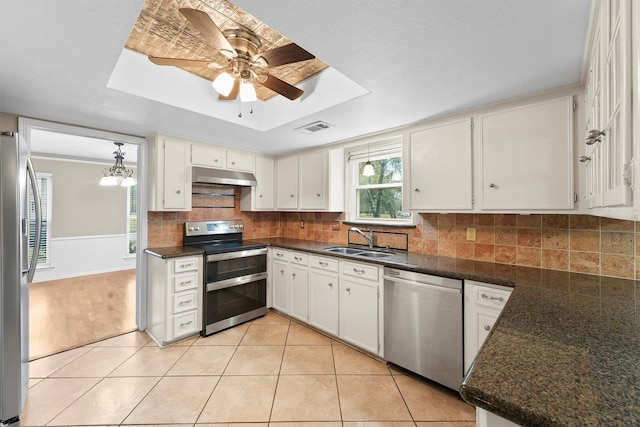 kitchen with light tile patterned flooring, stainless steel appliances, sink, and white cabinets