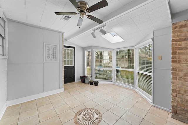 unfurnished sunroom featuring ceiling fan and lofted ceiling with skylight