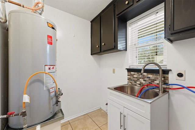 interior space with sink, water heater, white cabinets, light tile patterned flooring, and decorative backsplash