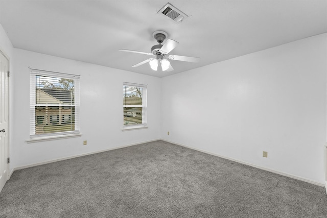 carpeted spare room with ceiling fan