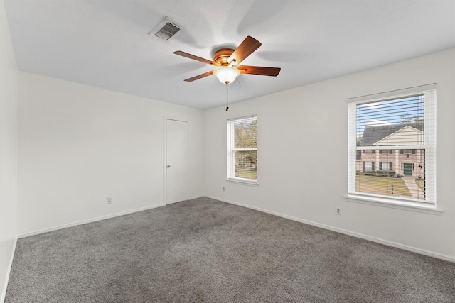 carpeted spare room featuring ceiling fan