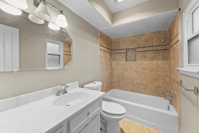 full bathroom with tiled shower / bath combo, vanity, tile patterned floors, and toilet