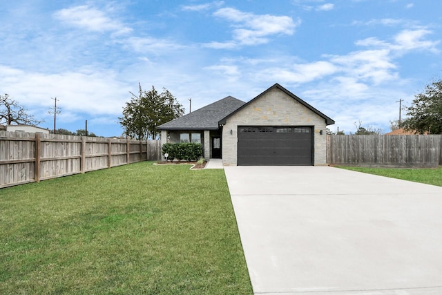 view of front of property featuring a garage and a front lawn