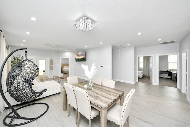 dining room featuring light hardwood / wood-style floors and ceiling fan