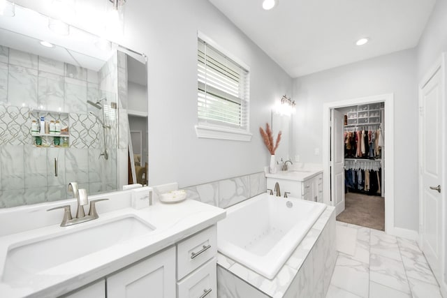 bathroom with vanity and shower with separate bathtub