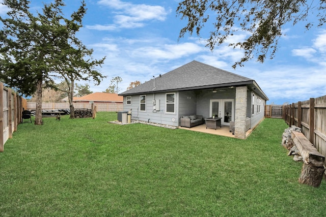 back of house with a yard, an outdoor hangout area, french doors, and a patio area