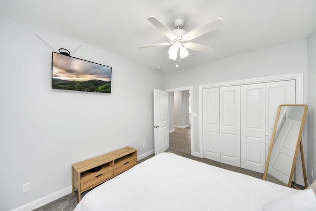 carpeted bedroom featuring ceiling fan and a closet