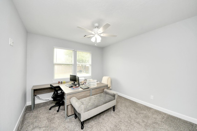 home office featuring light carpet and ceiling fan