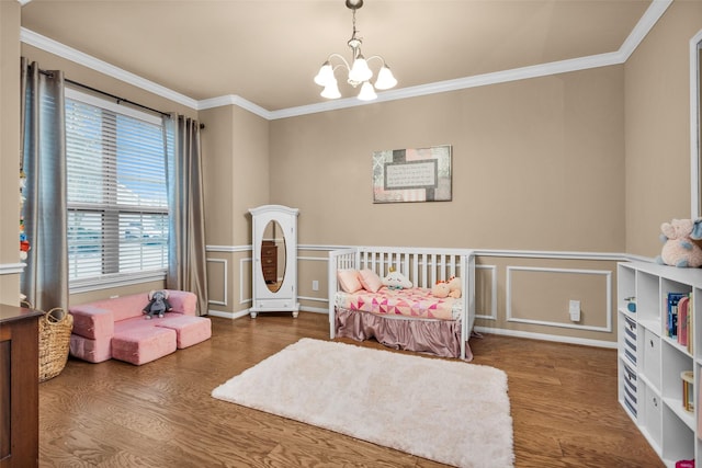 bedroom featuring an inviting chandelier, ornamental molding, and hardwood / wood-style floors