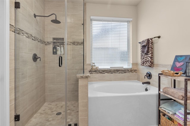 bathroom featuring shower with separate bathtub