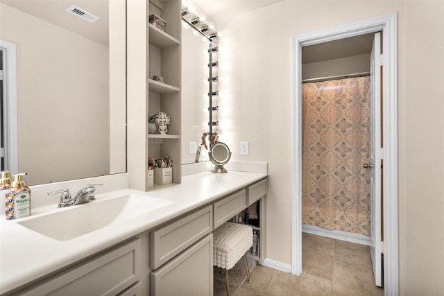 bathroom featuring vanity, curtained shower, and tile patterned floors