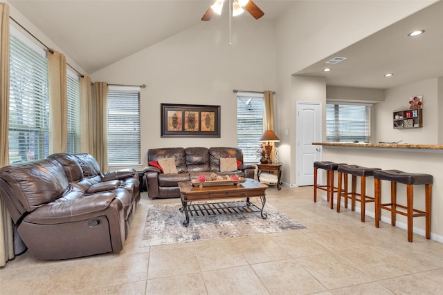 tiled living room featuring high vaulted ceiling and ceiling fan