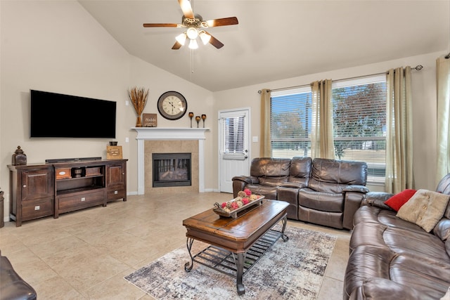 tiled living room with a tiled fireplace, lofted ceiling, and ceiling fan