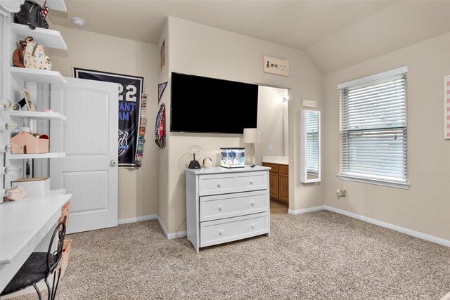 bedroom featuring lofted ceiling and light carpet