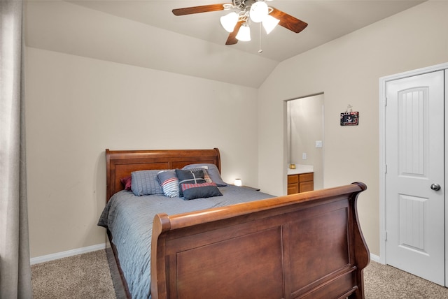 carpeted bedroom featuring lofted ceiling, connected bathroom, and ceiling fan