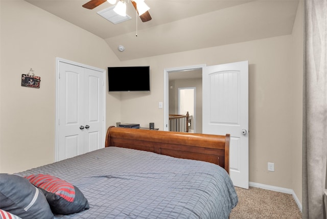 carpeted bedroom with vaulted ceiling, ceiling fan, and a closet