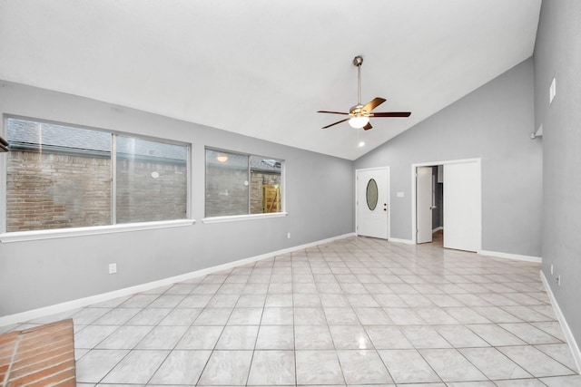 empty room with high vaulted ceiling, a healthy amount of sunlight, and ceiling fan