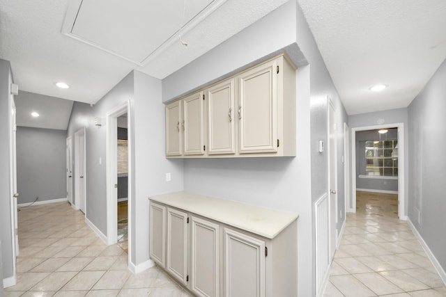 hall featuring light tile patterned floors