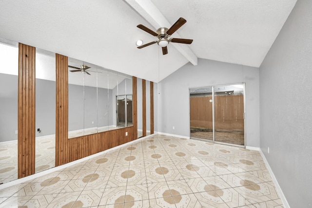 unfurnished room with ceiling fan, lofted ceiling with beams, and a textured ceiling