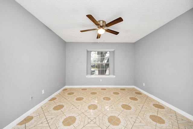 tiled spare room with ceiling fan